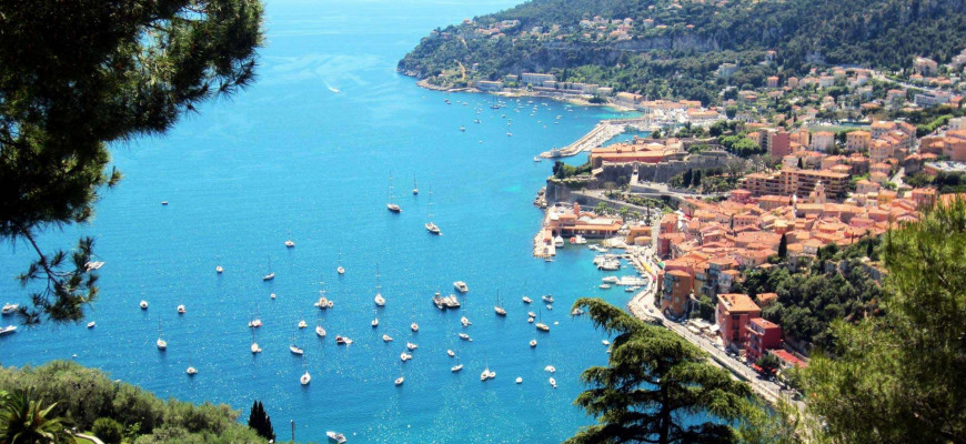 Mediterranean shoreline of the French Riviera with sandy cove and beach umbrellas