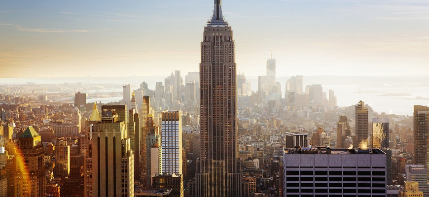 Empire State Building rising above the New York skyline at twilight with Midtown Manhattan in the background