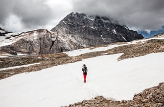 Hiker with backpack in the Swiss Alps