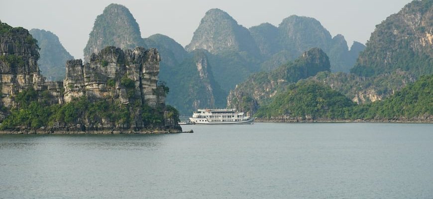 Traditional boat sailing through limestone karst islands of Halong Bay, Vietnam