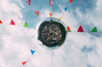 Festival disco ball with colorful pennant flags against cloudy sky representing Breckenridge year-round events