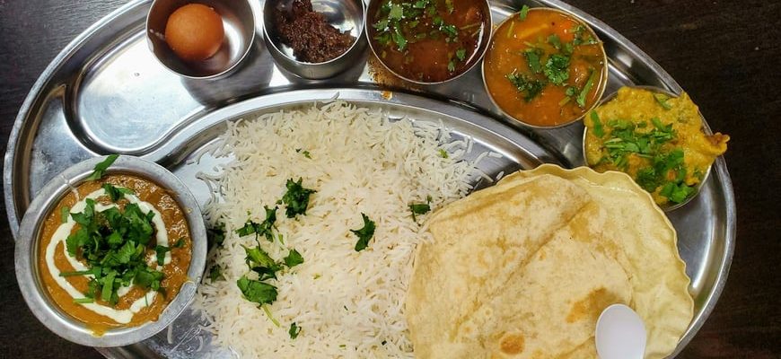 Steel thali with rice, dal, sabzi and chutneys