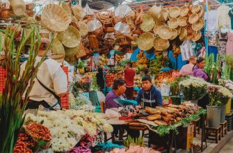 Mexican market stall with dried chiles, produce, and shoppers in Cholula Puebla