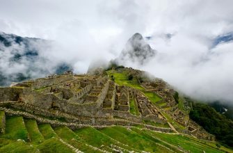 Machu Picchu Inca citadel ruins seen across terraces with mountain backdrop