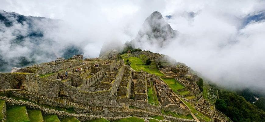 Machu Picchu Inca citadel ruins seen across terraces with mountain backdrop