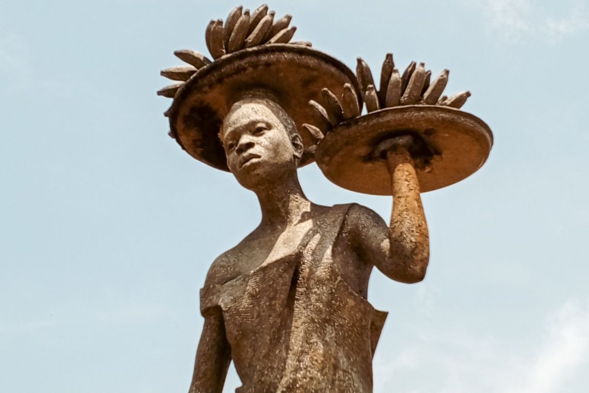 A contemporary bronze public sculpture of a figure in Africa