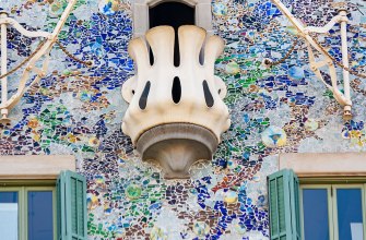 The colourful trencadis facade and bone-shaped balcony of Casa Batllo by Gaudi