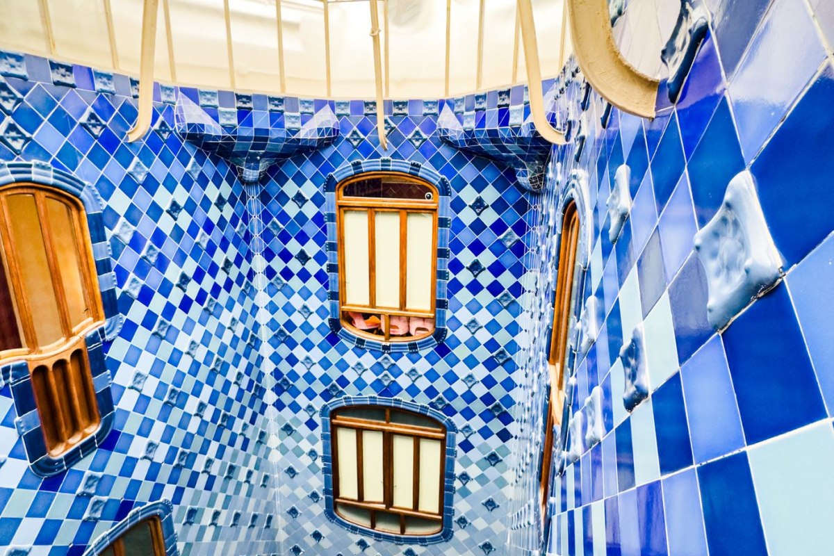 The graded blue-tiled central lightwell inside Casa Batllo by Gaudi