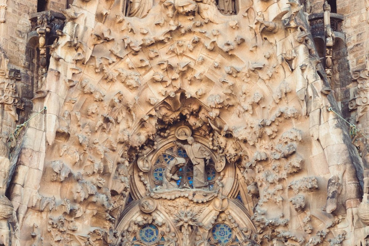 Dense carved stone figures on a facade of the Sagrada Familia