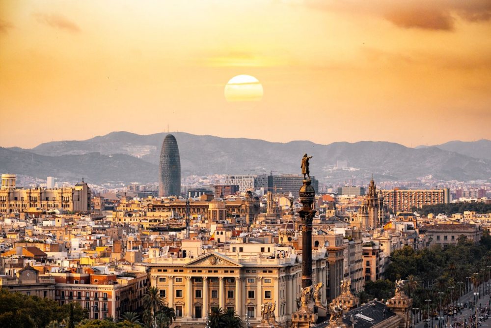 Barcelona at sunset with the Columbus column and the Torre Glories
