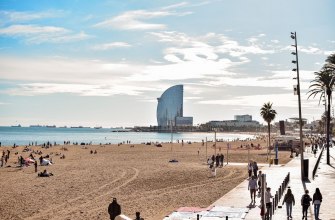 Barceloneta beach with the palm-lined promenade and the sail-shaped W hotel beyond