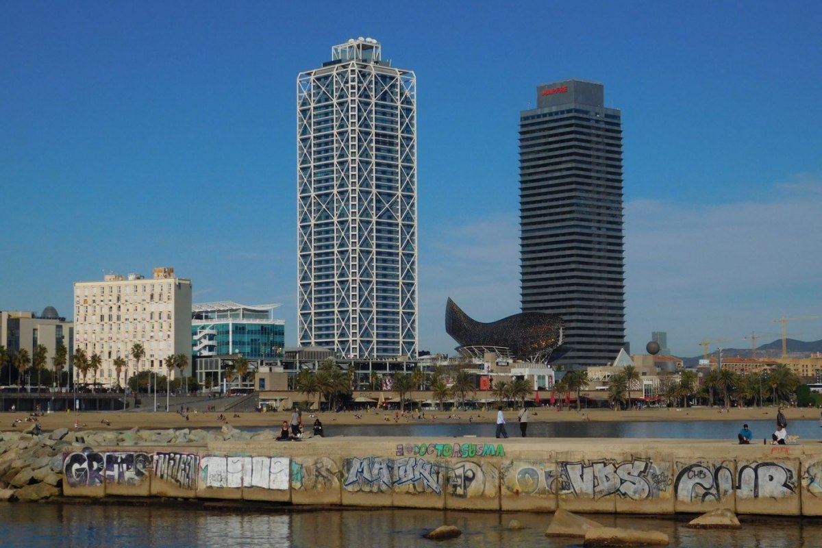 The Port Olimpic towers and Frank Gehry golden Fish above the Barcelona beach