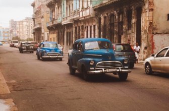 Blue classic American cars, one a taxi, on a Havana street in Cuba