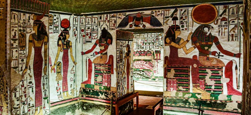 A New Kingdom Egyptian tomb chamber painted with seated gods and hieroglyphs