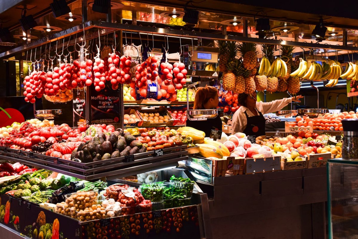 A colourful fruit and produce stall at La Boqueria market in Barcelona