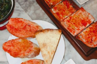 A Barcelona tapas spread with pa amb tomaquet, patatas bravas, padron peppers and croquetas