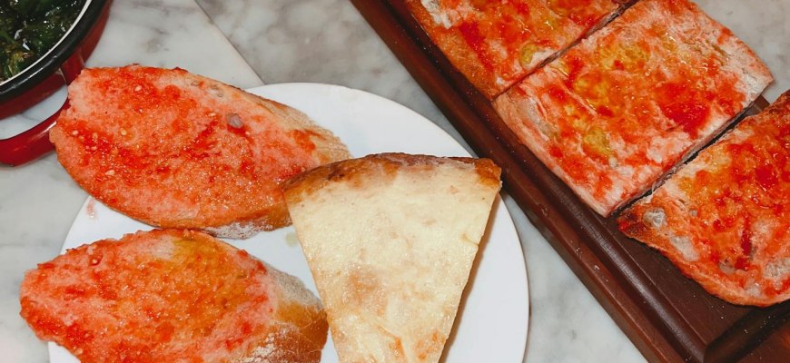 A Barcelona tapas spread with pa amb tomaquet, patatas bravas, padron peppers and croquetas