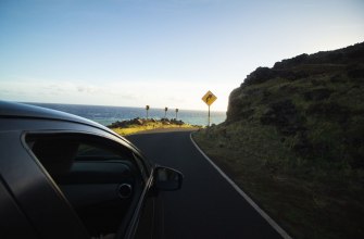 A car driving along a scenic coastal road
