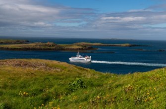 A passenger ferry crossing coastal waters between islands