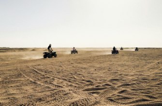 A group riding off-road across dry sandy terrain