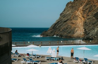 Tranquil resort poolside with ocean and cliff views