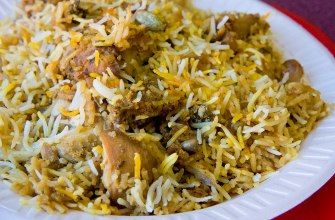 Hyderabadi chicken dum biryani with saffron rice and fried onions