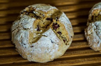 A round Irish soda bread loaf with a cross cut in the top