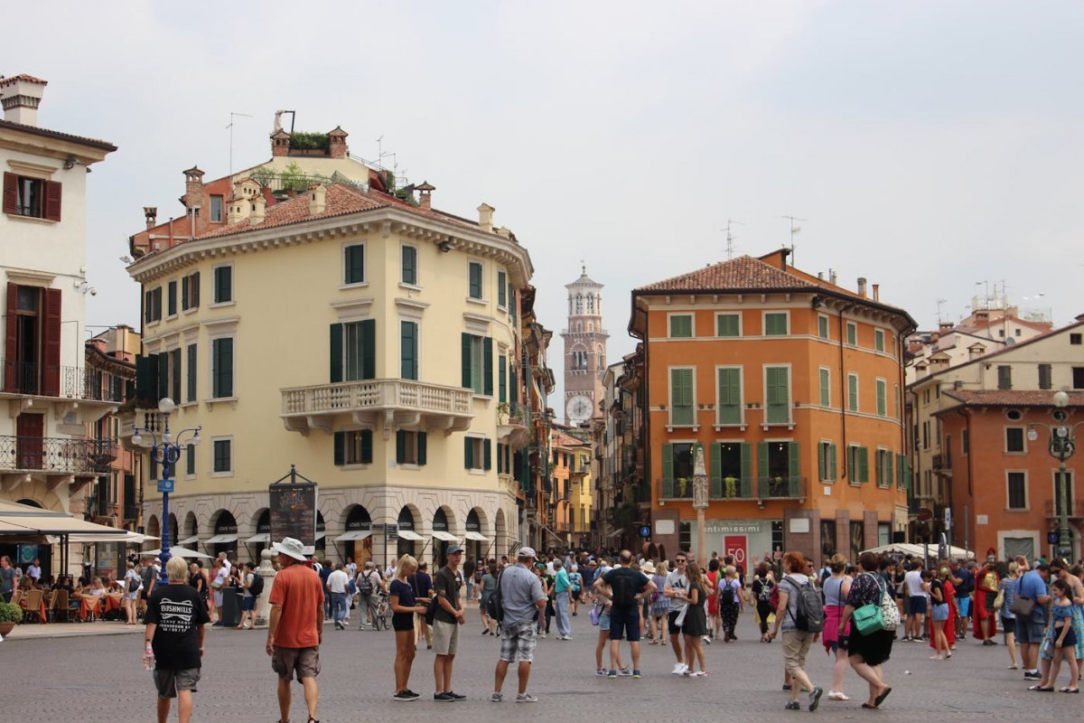The lively Piazza delle Erbe in Verona with cafes and market stalls