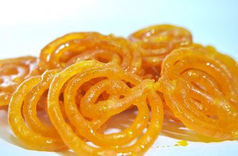 Crisp orange jalebi spirals soaked in sugar syrup