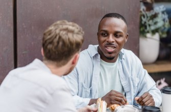 A small group of friends talking and sharing food together