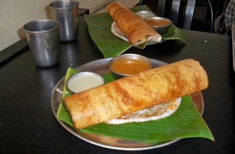 Crisp golden masala dosa folded over spiced potato with chutney and sambar