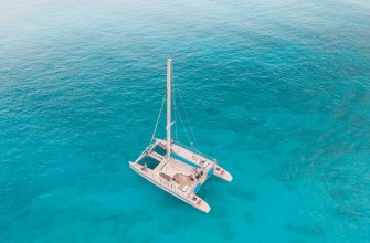 A catamaran anchored over turquoise water