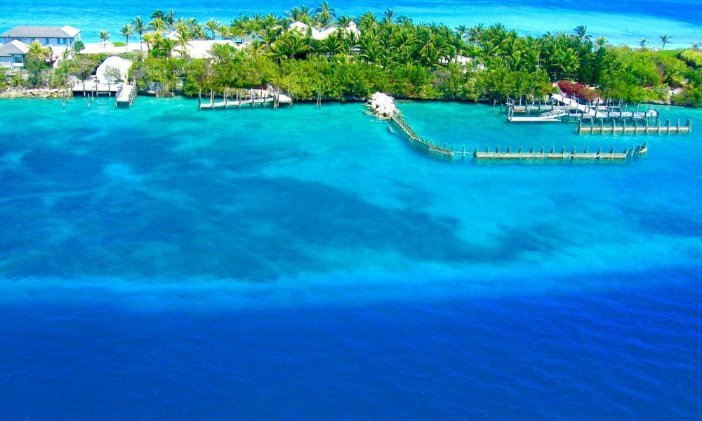 Aerial view of a Bahamian cay with docks and turquoise water