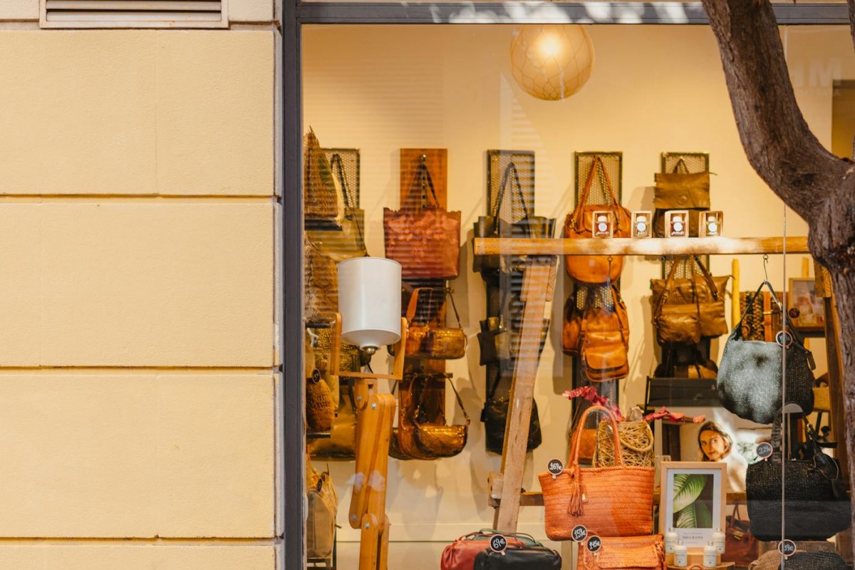 A handbag boutique window display behind glass in Barcelona