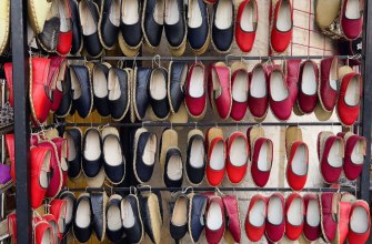 A wall display of colourful handmade espadrilles for sale in Barcelona