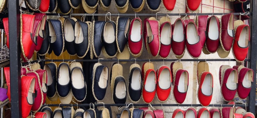 A wall display of colourful handmade espadrilles for sale in Barcelona