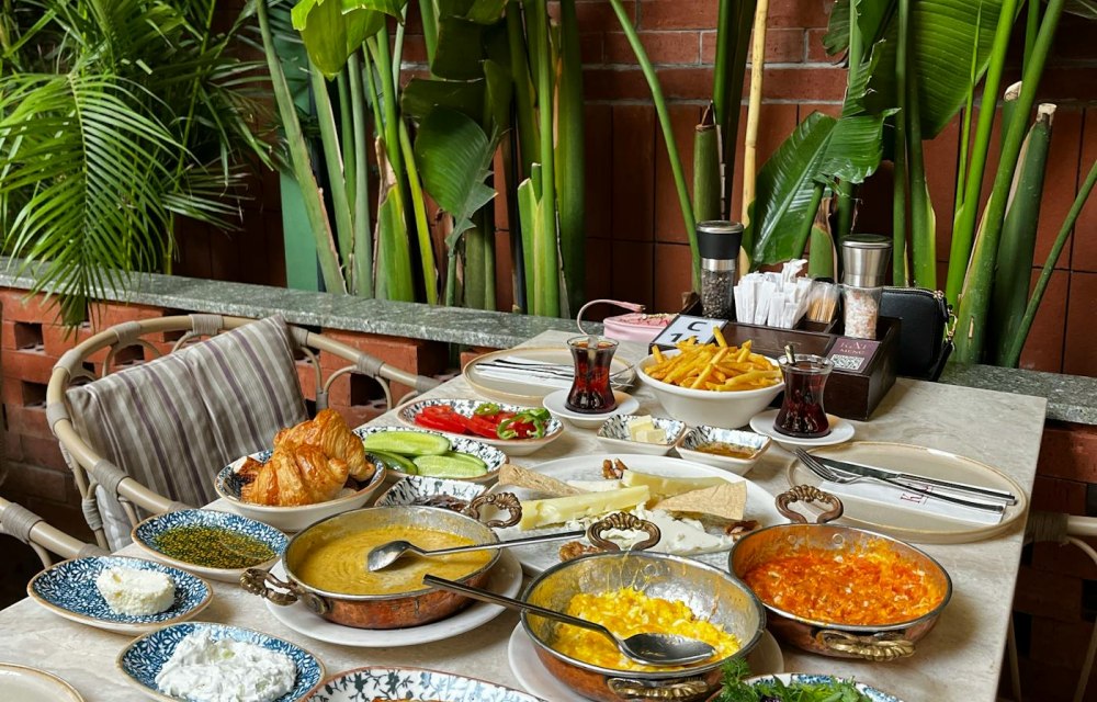 A Turkish breakfast spread of cheeses, olives, eggs, jams and tea