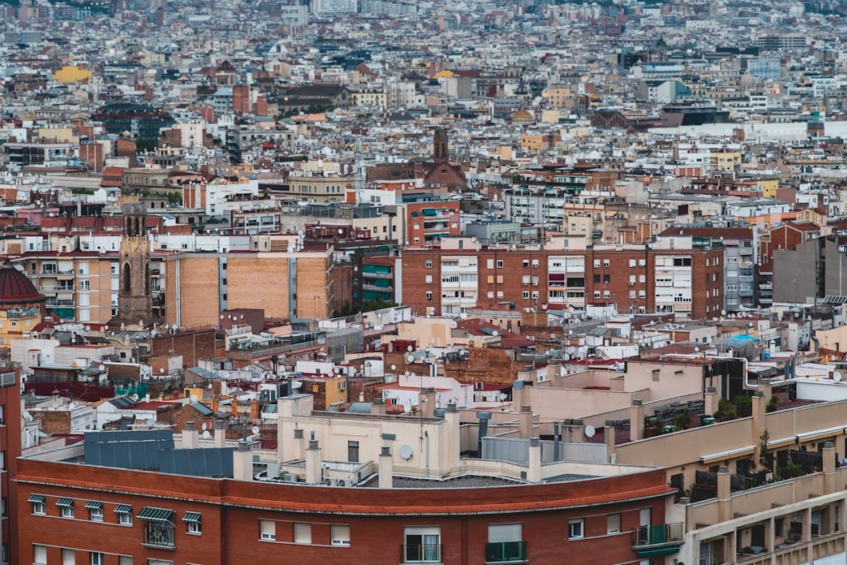 Aerial view of mixed residential rooftops and buildings across Barcelona
