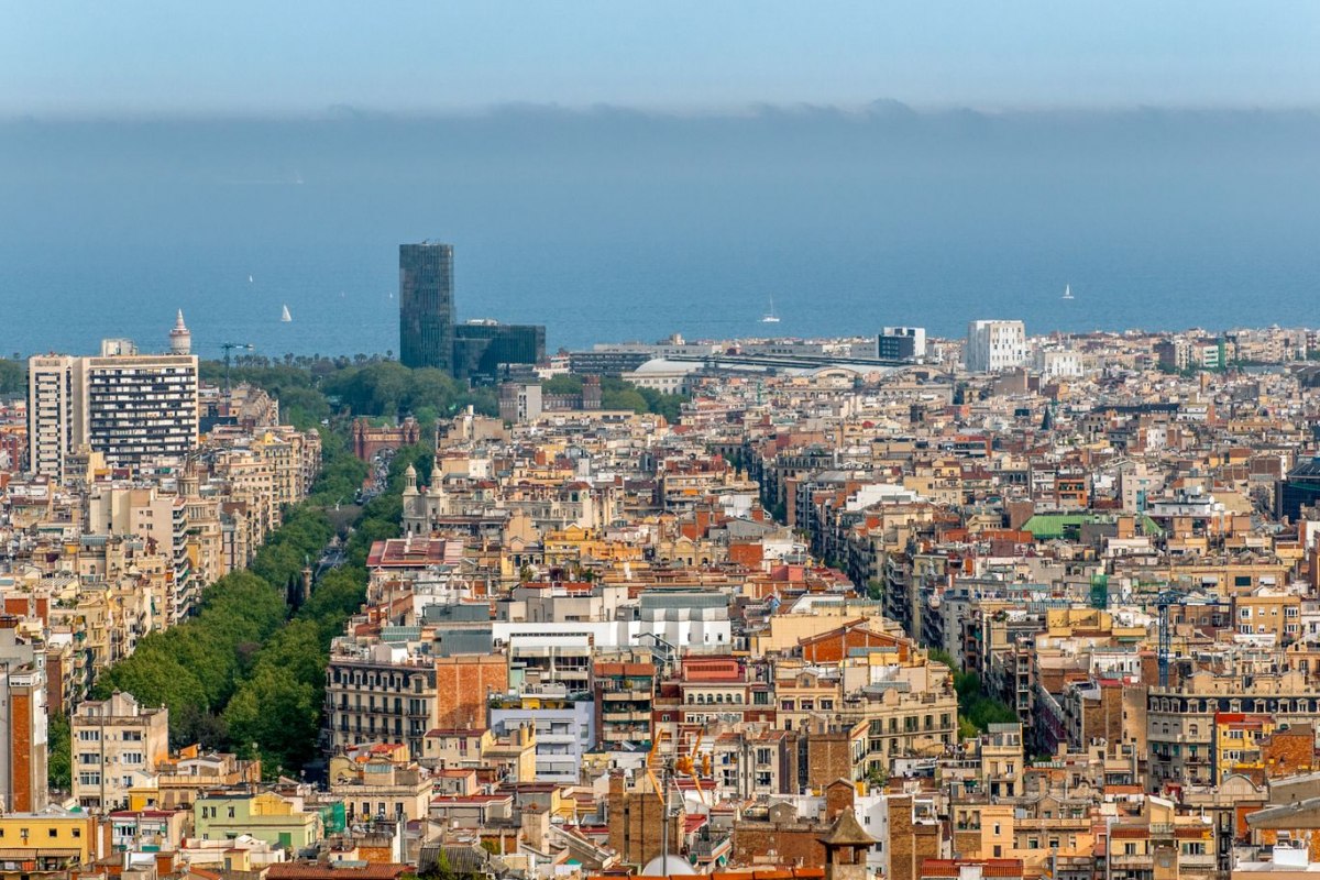 Aerial view of Barcelona architecture stretching toward the seaside horizon